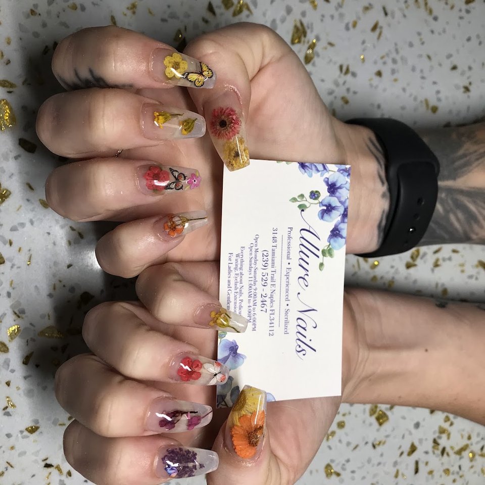 Manicured nails beside a polish display.